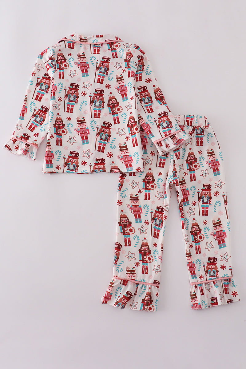 Children's pajama set with robot pattern on a light gray background