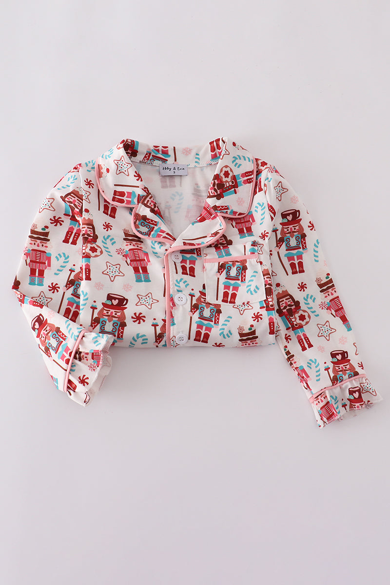 Children's pajama top with nutcracker pattern on a white background