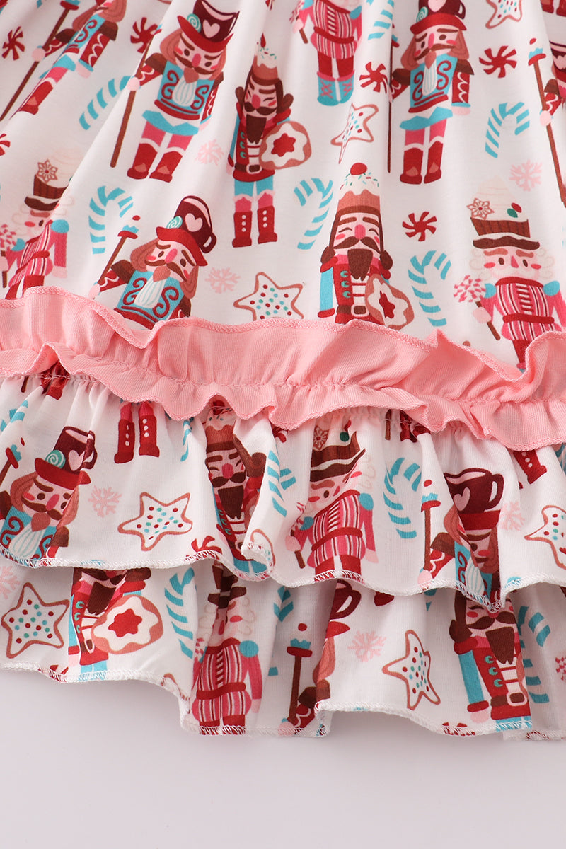 Ruffled fabric with nutcracker and candy cane pattern on a white background