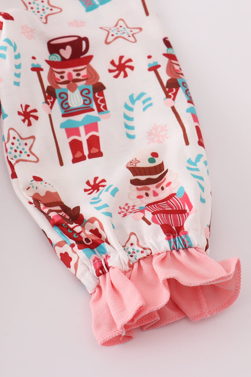 Children's leggings with nutcracker and candy cane pattern on a white background