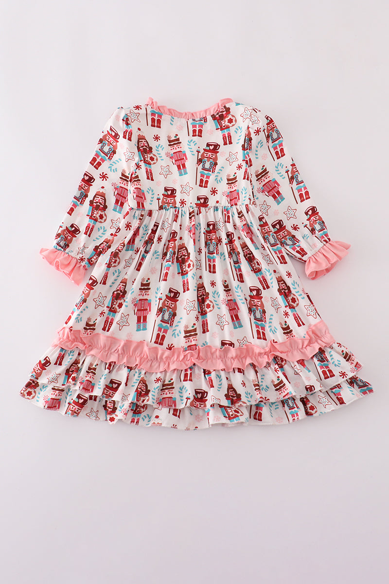 Children's dress with nutcracker pattern on a light gray background