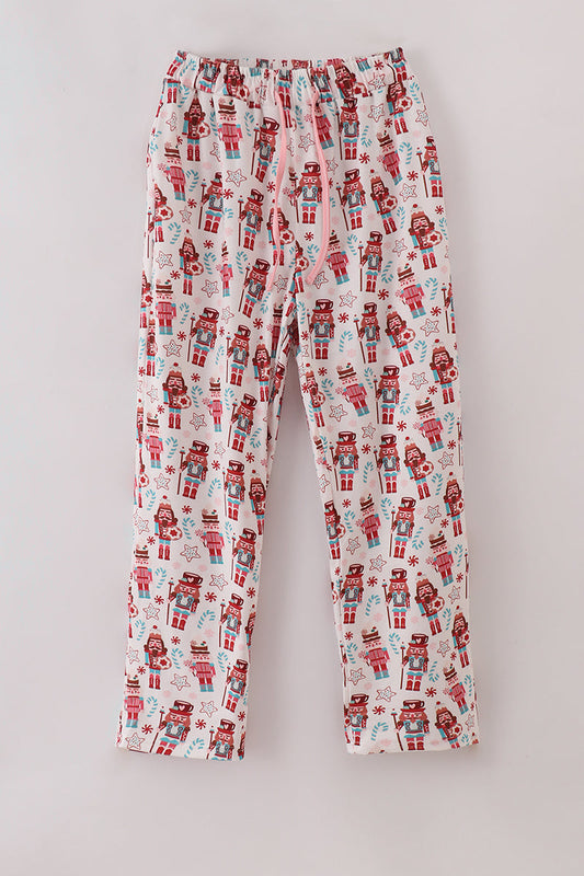 Pajama pants with nutcracker pattern on a light gray background
