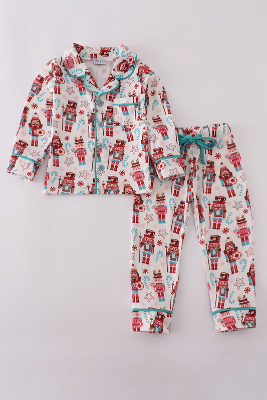 Children's pajama set with robot pattern on a light gray background