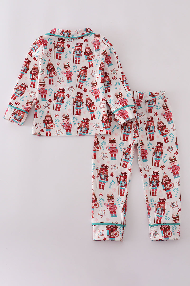 Children's pajama set with robot and gift print on a light gray background