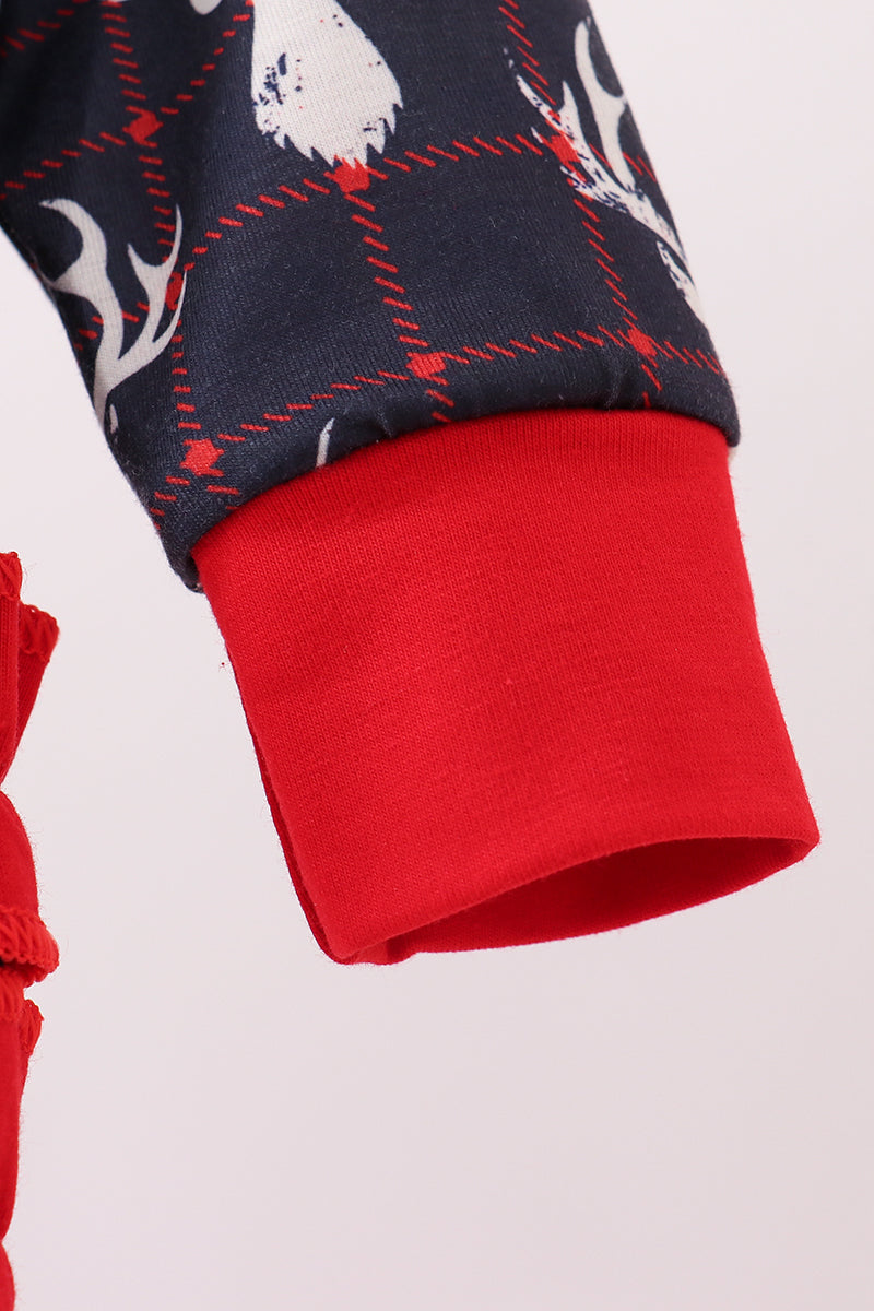 Close-up of a red and navy patterned fabric with a white design on a light pink background