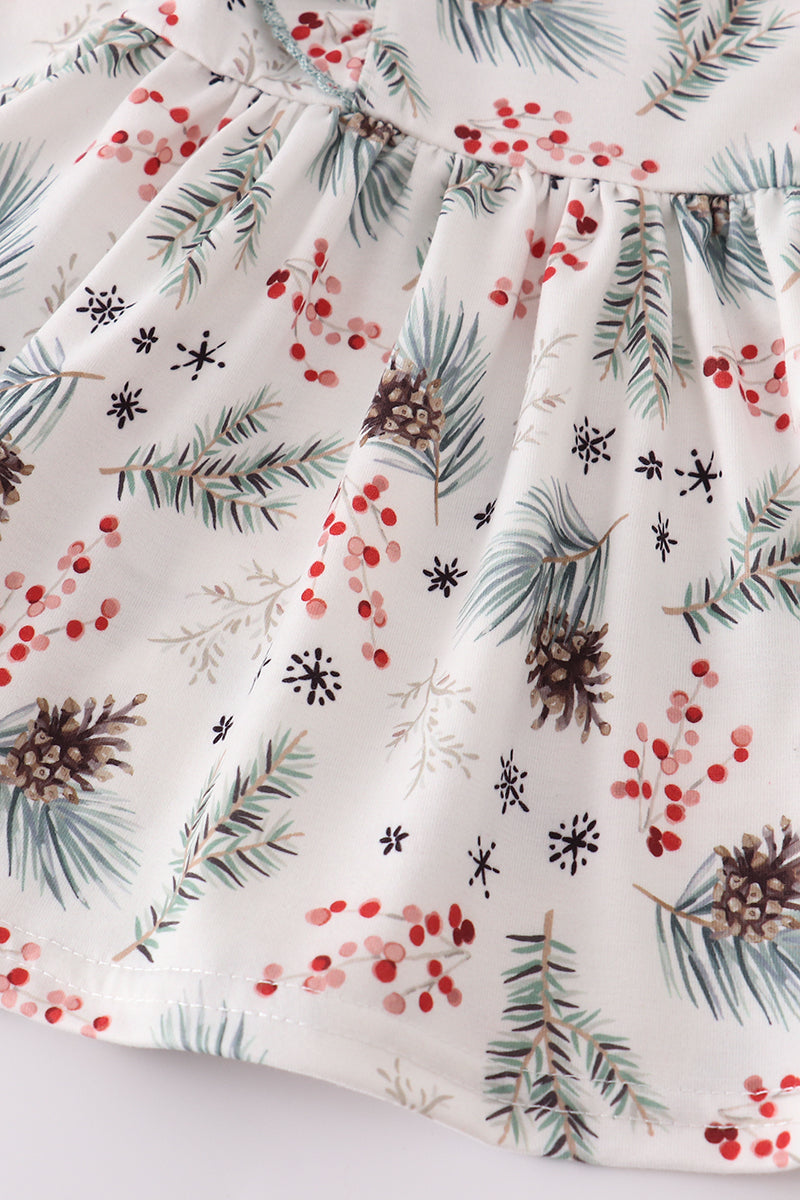 Fabric with Christmas-themed pattern featuring pine cones, berries, and snowflakes on a white background.