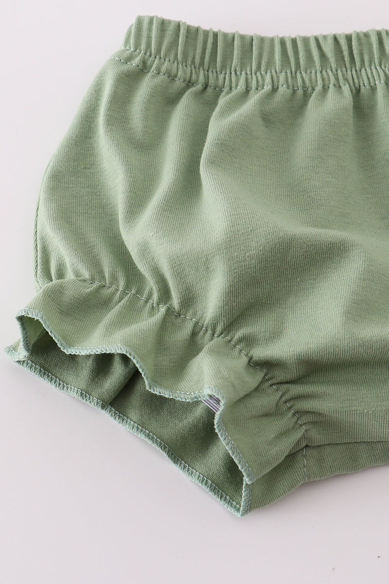 Green baby bloomers on a white background