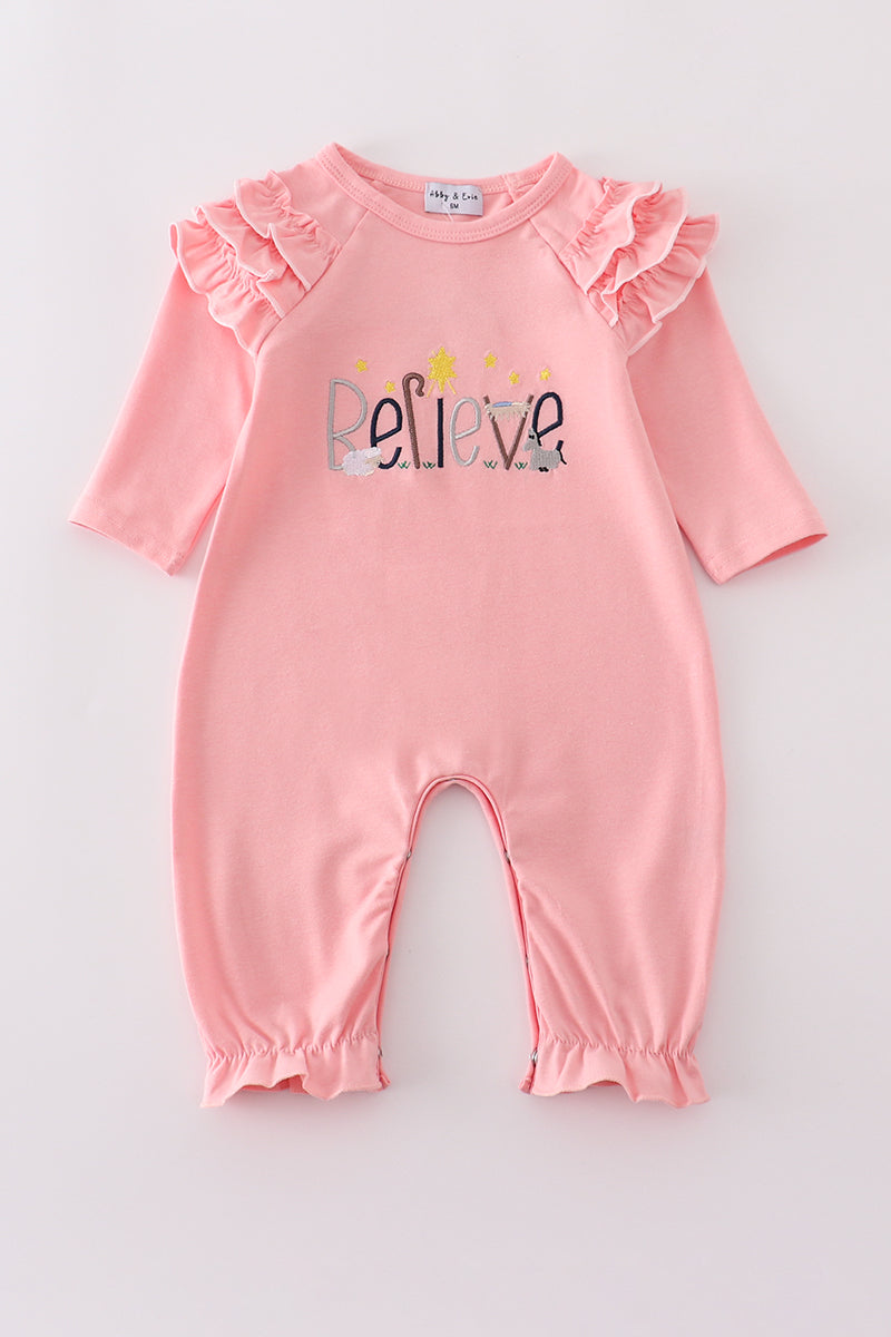 Pink baby romper with 'Believe' text on a light gray background
