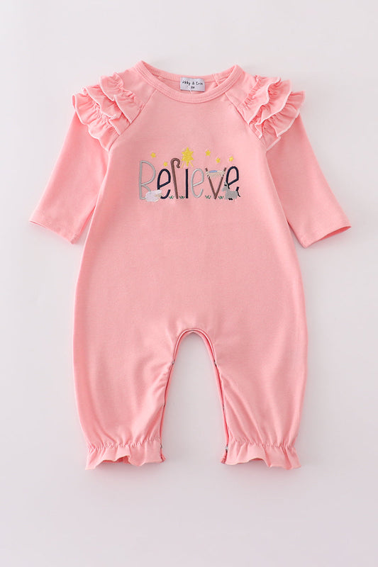 Pink baby romper with 'Believe' text on a light gray background