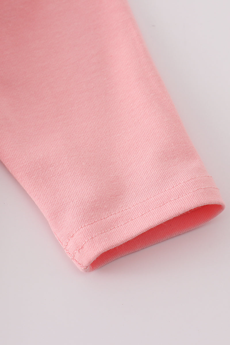 Close-up of a pink fabric roll on a light gray background
