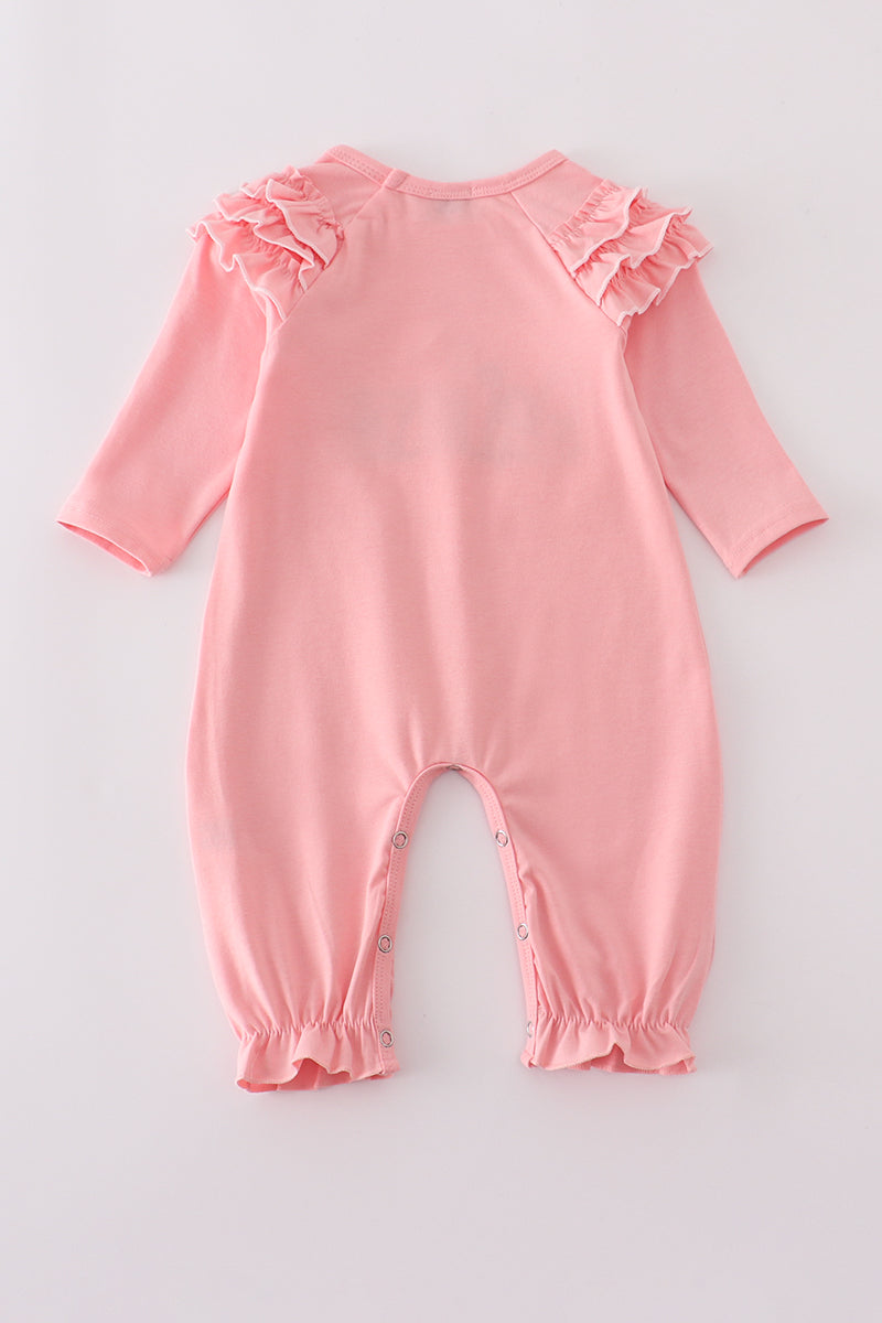 Pink baby romper with ruffled sleeves on a light gray background