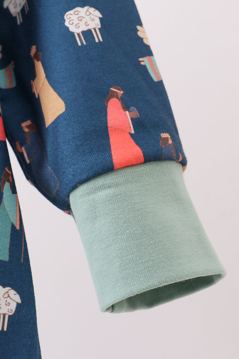Close-up of a fabric with shepherd and sheep pattern on a blue background