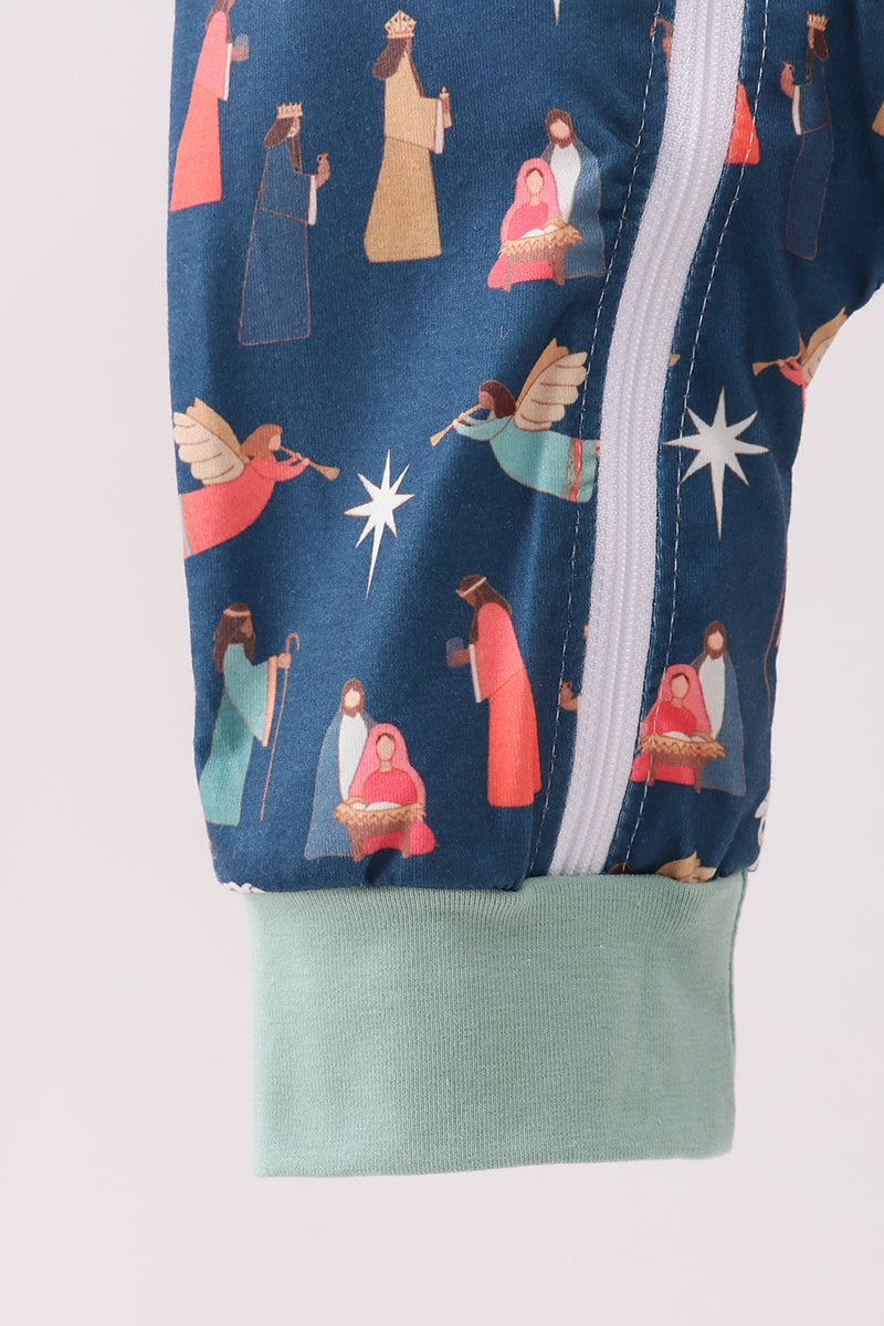 Close-up of a navy blue jacket with Christmas nativity scene print on a white background