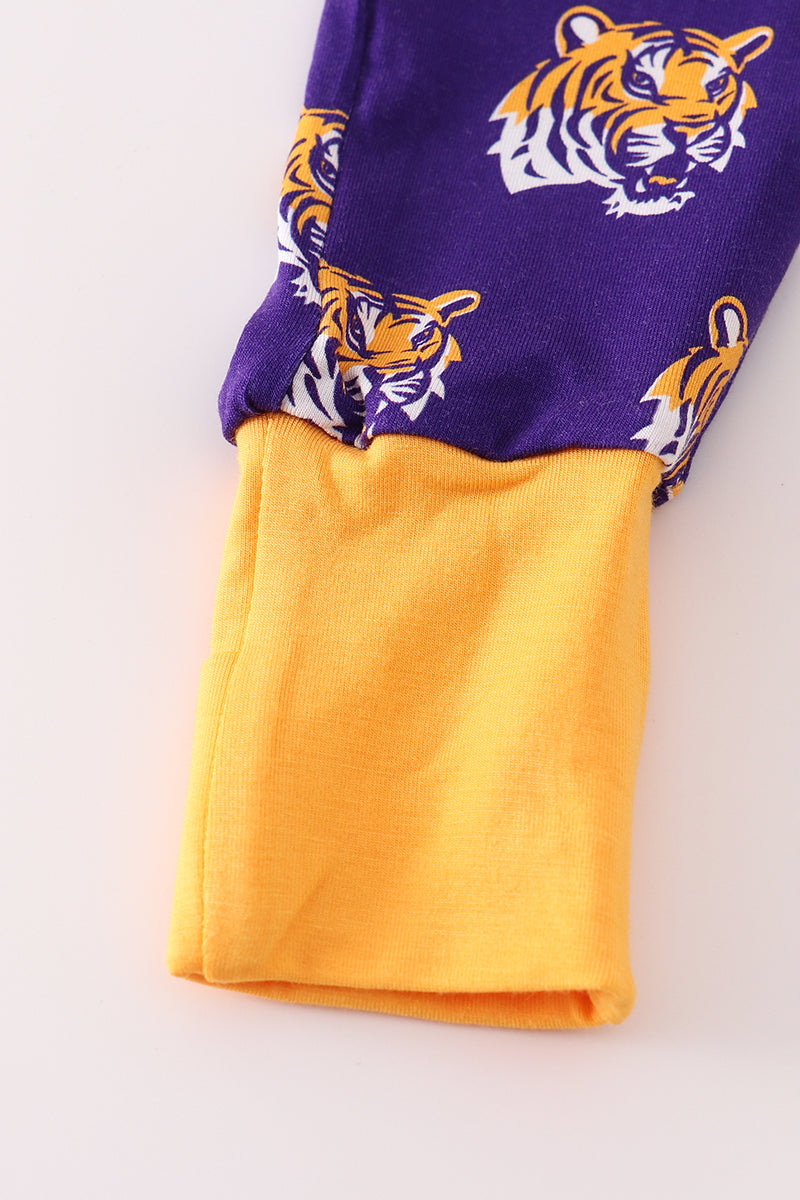 Purple and yellow fabric with tiger logo pattern on a white background