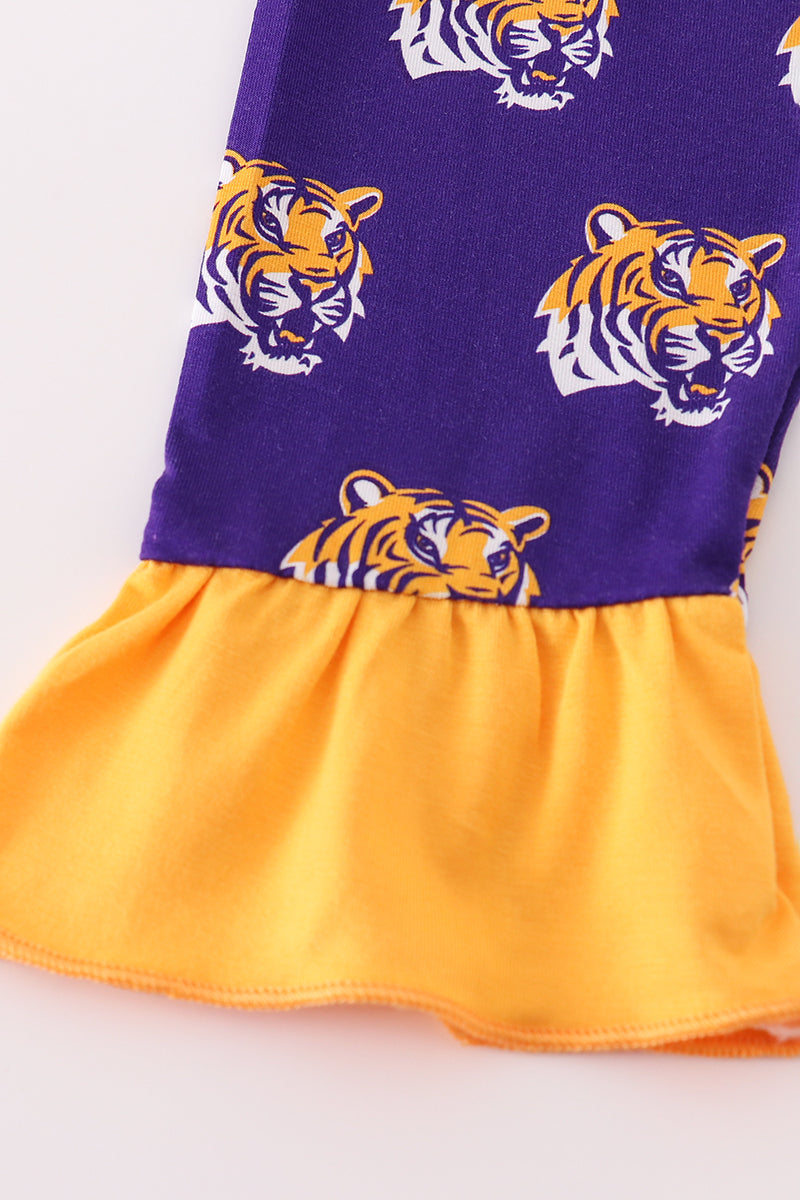 Dress with tiger head pattern on a purple and yellow background