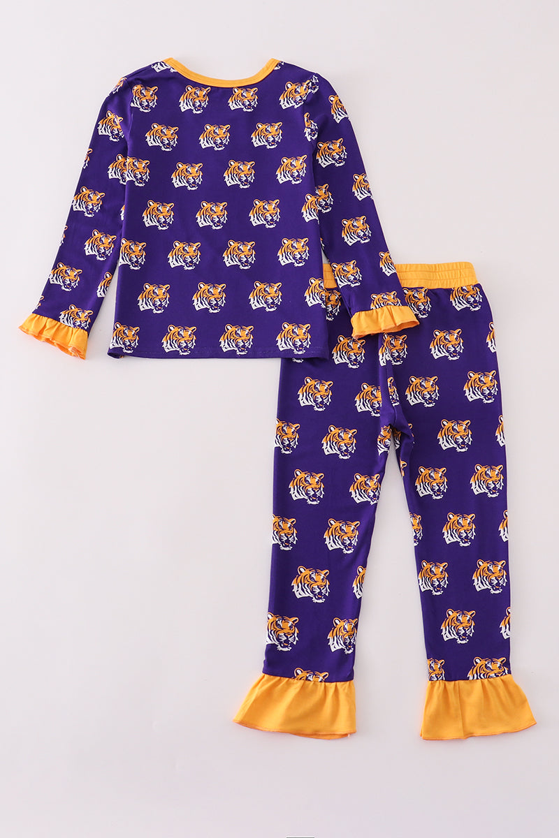 Purple pajama set with tiger pattern and yellow ruffles on a white background