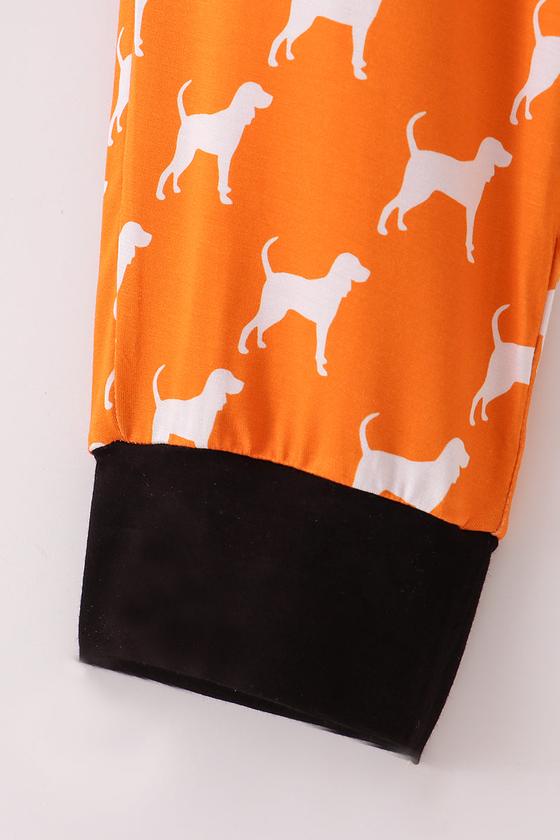 Orange fabric with white dog pattern and black bottom edge on a white background