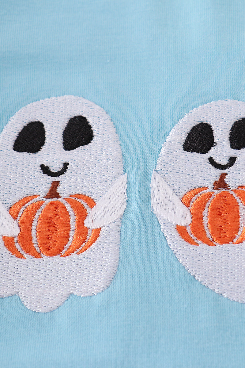 Two ghost patches with pumpkin faces on a light blue background
