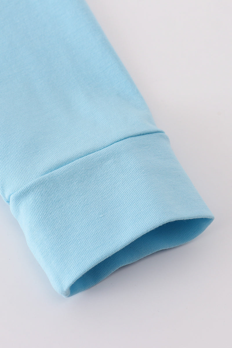 Close-up of a light blue fabric sleeve on a white background