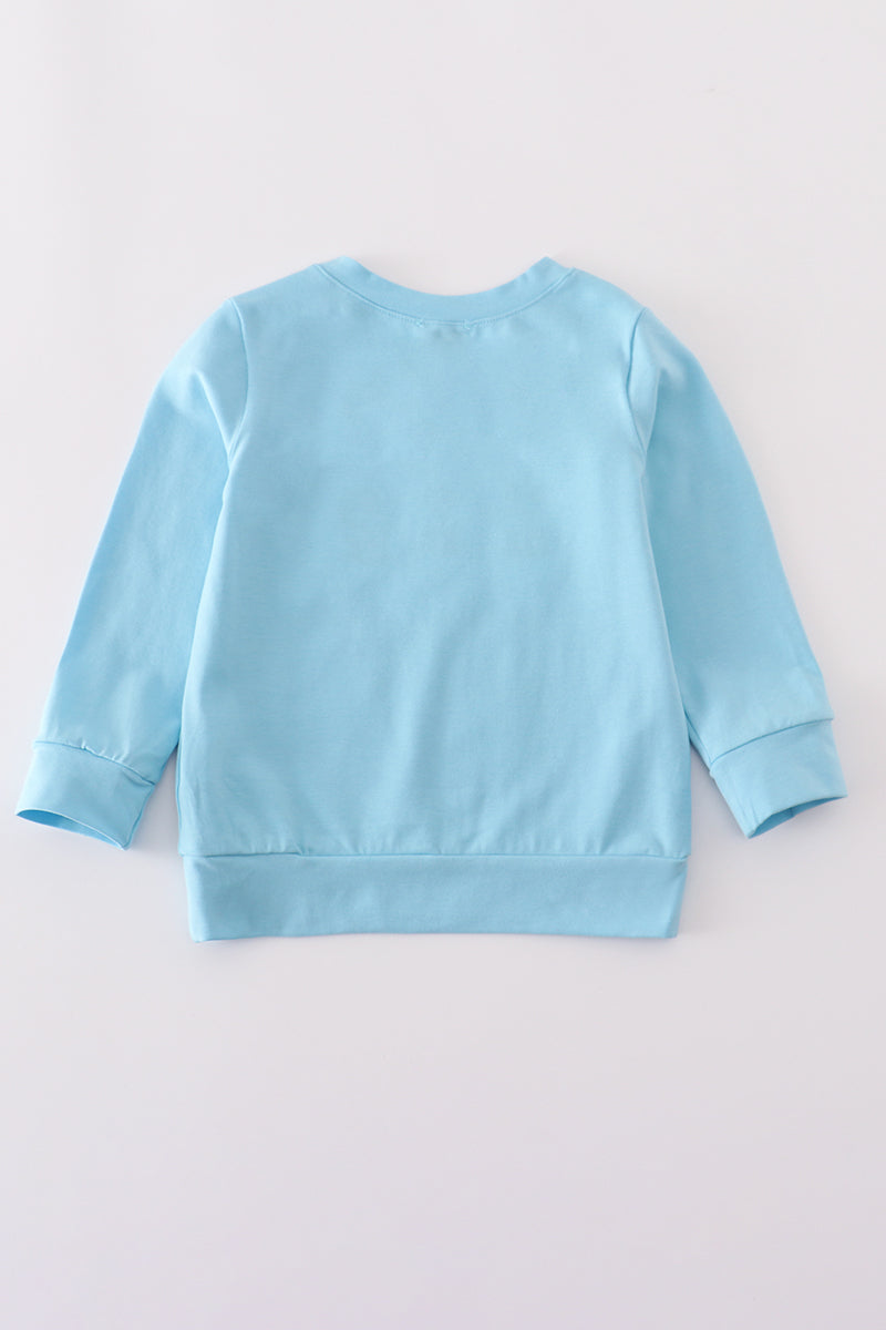 Light blue sweatshirt on a light gray background