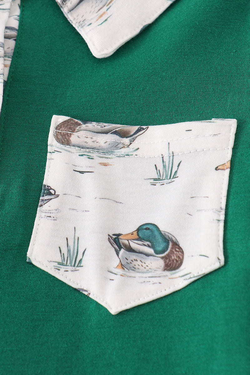 Green shirt with a pocket featuring duck illustrations on a white background