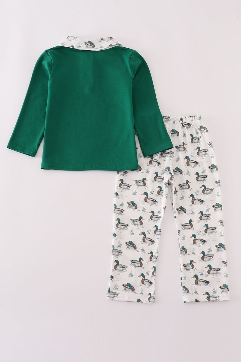 Green long-sleeve top and duck-patterned pants on a white background