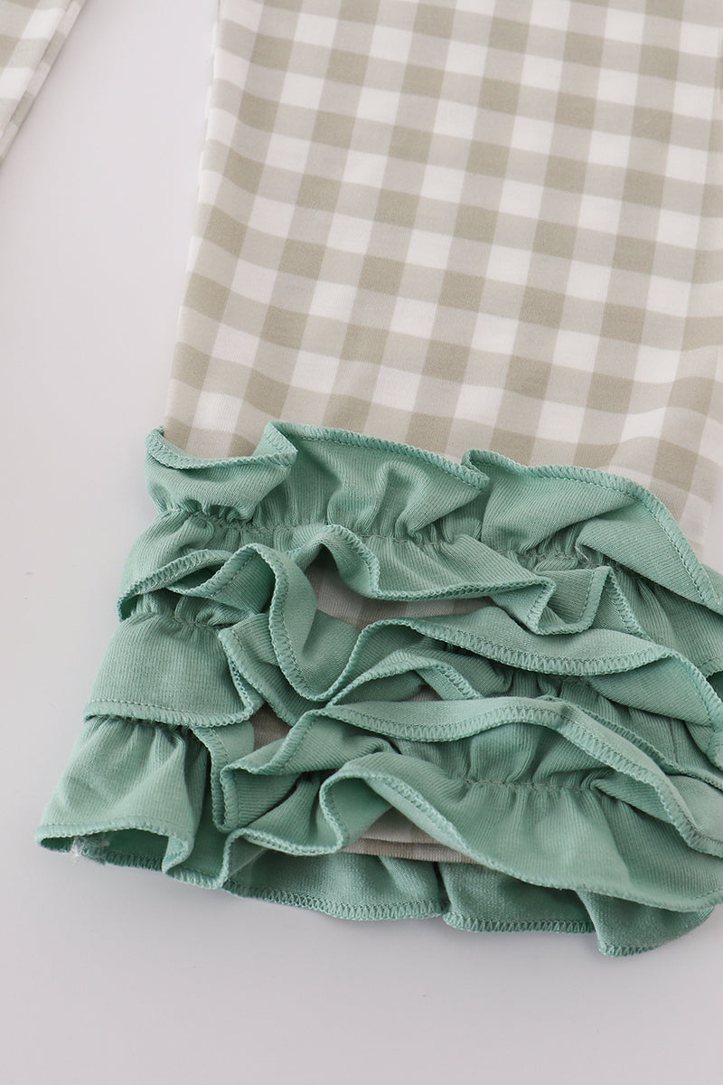 Green ruffled fabric on a checkered background