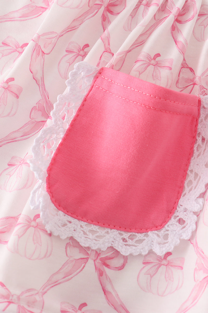 Close-up of a pink pocket with lace trim on a floral background