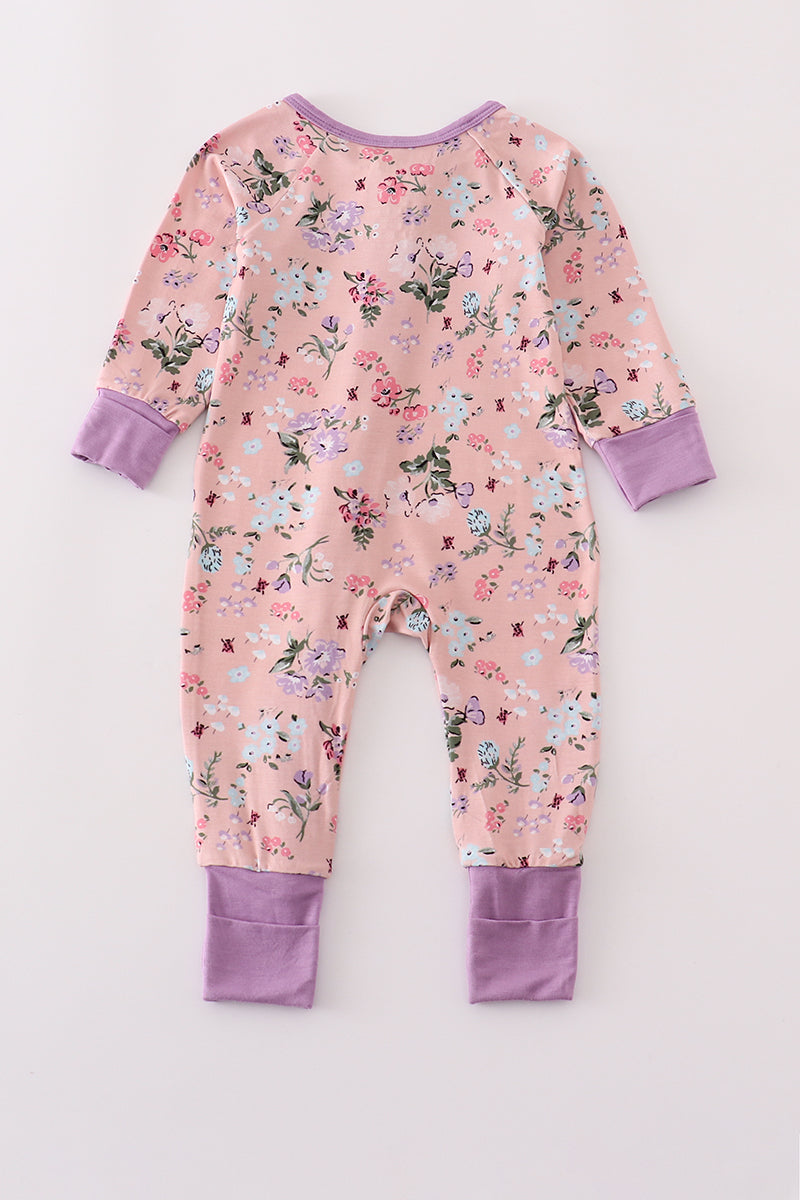 Floral baby onesie with purple accents on a white background