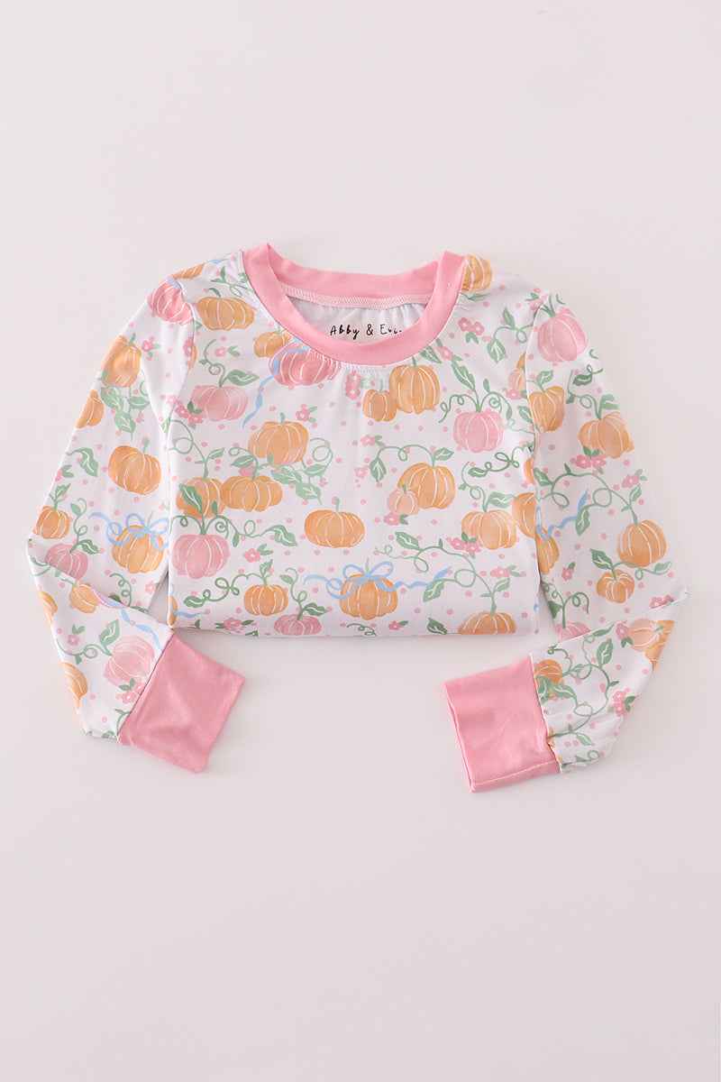 Children's pajama set with pumpkin pattern on a light gray background