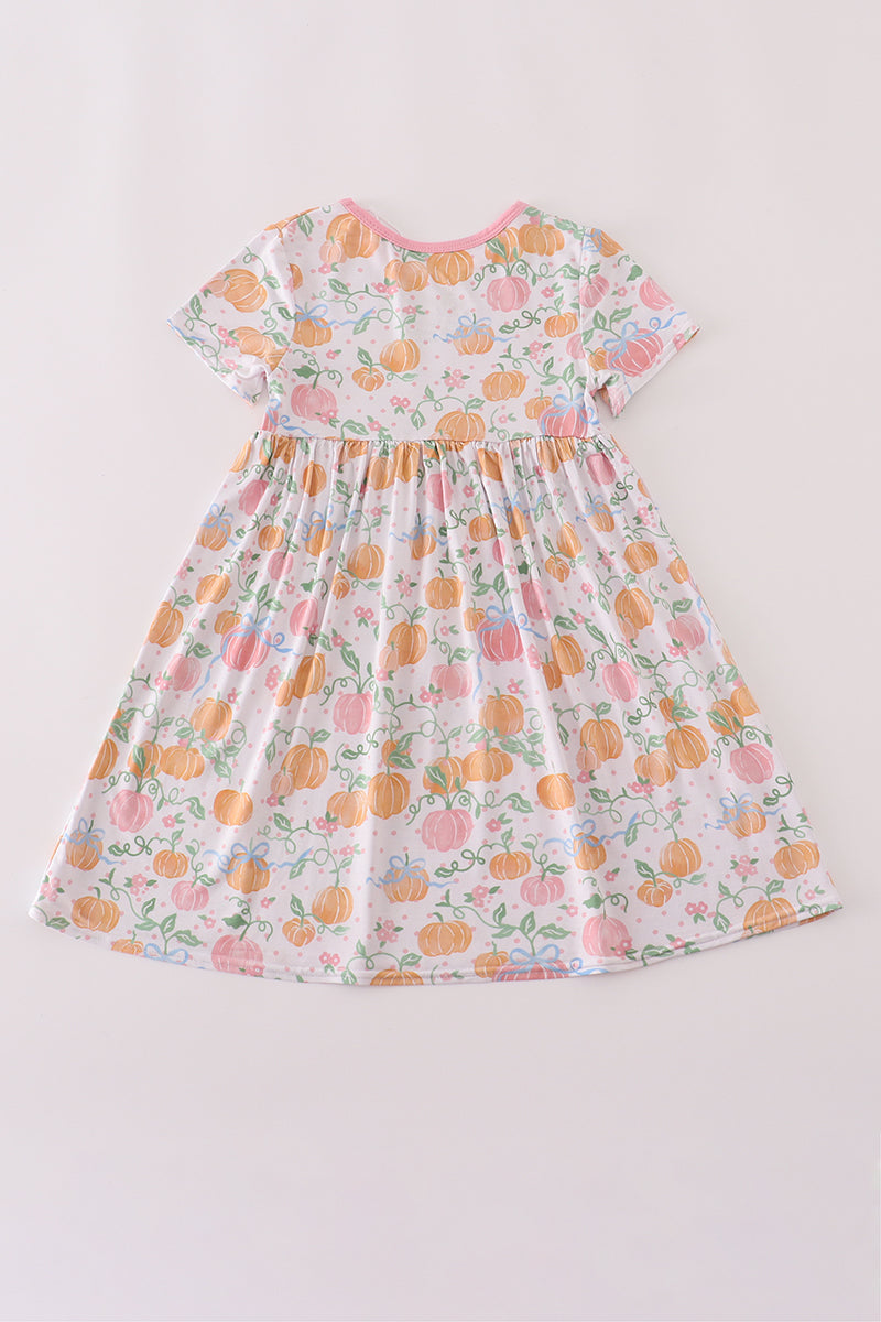 Floral dress with pumpkins on a plain background