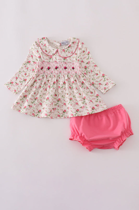Floral dress with pink bloomers on a light gray background