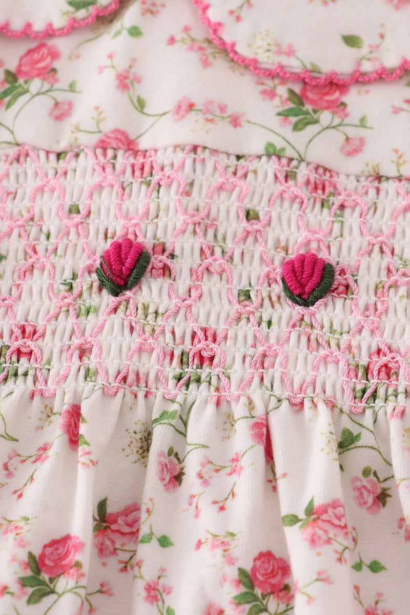 Floral dress with pink roses and green leaves on a white background