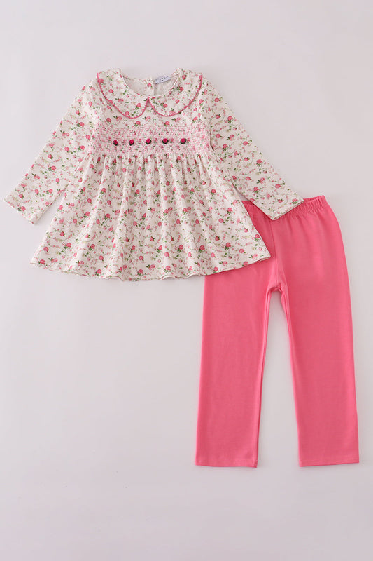 Floral dress and pink leggings set on a light gray background