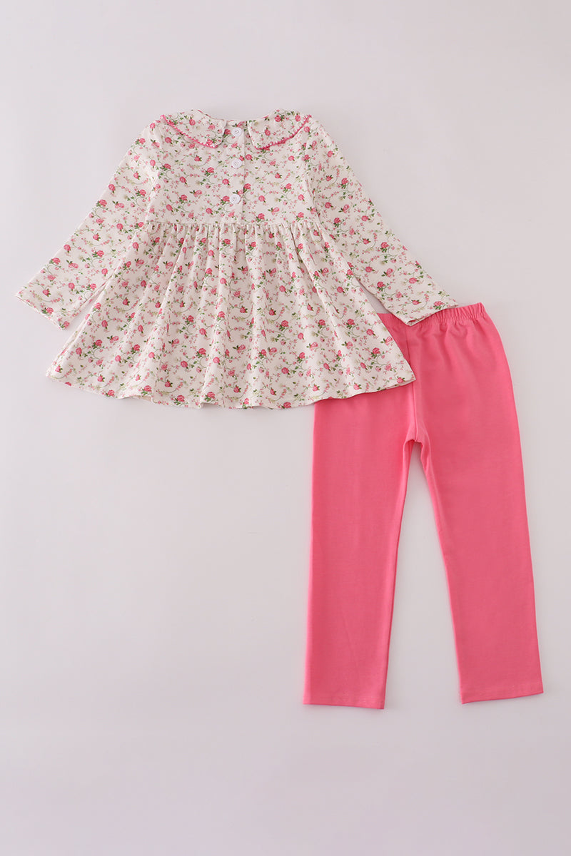 Floral top and pink leggings set on a light gray background