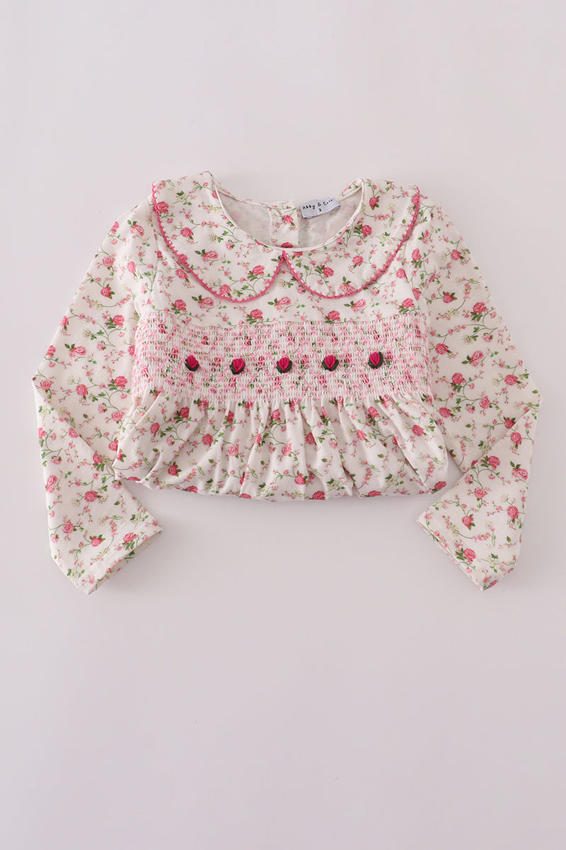 Floral blouse with a ruffled collar on a light gray background