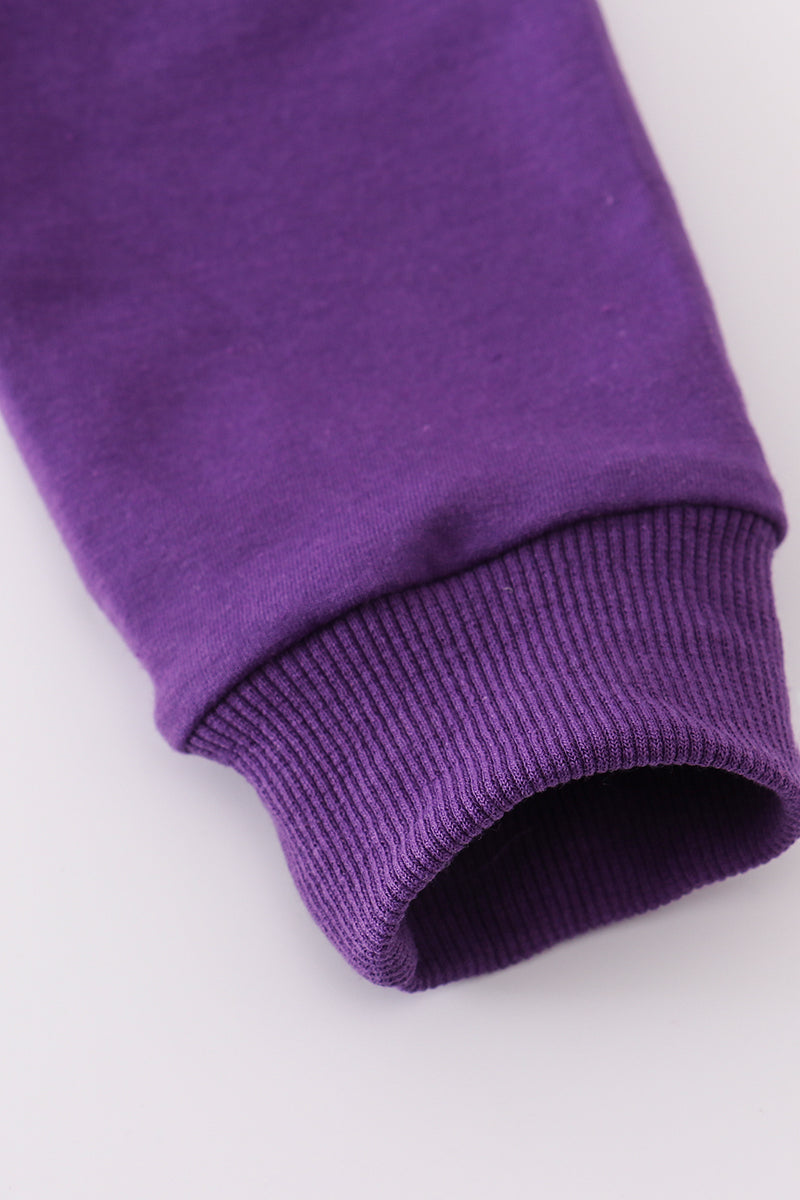 Close-up of a purple fabric roll on a white background
