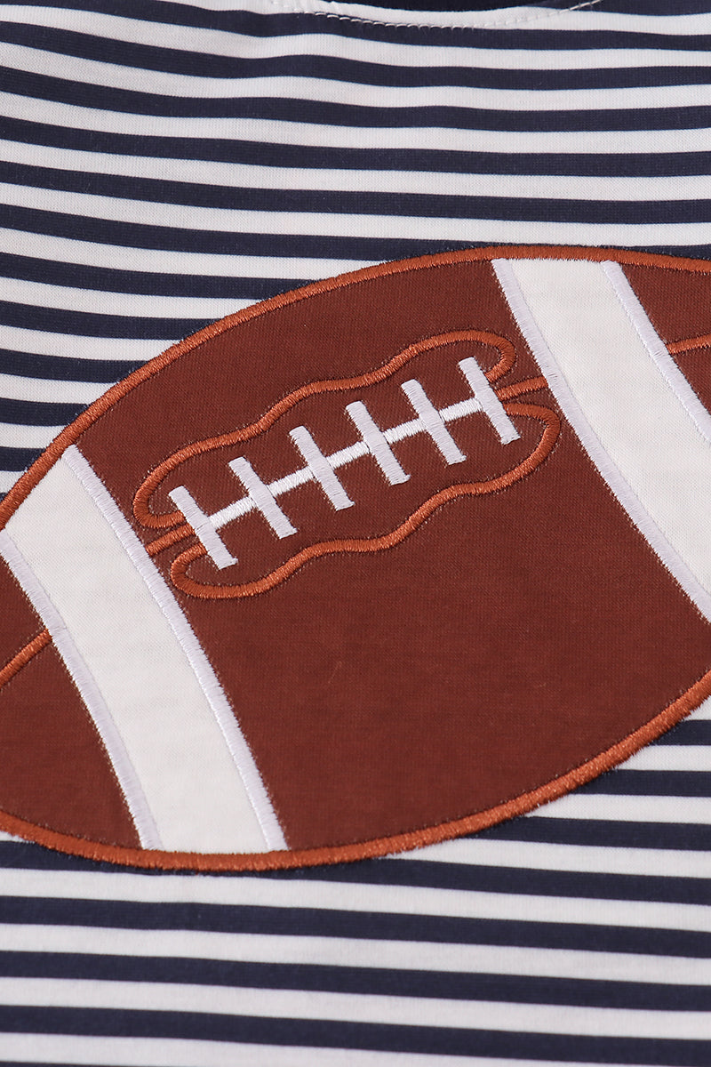Close-up of a shirt with a football applique on a striped background