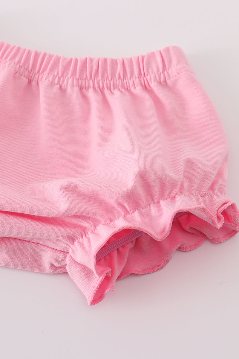 Pink baby bloomers on a white background