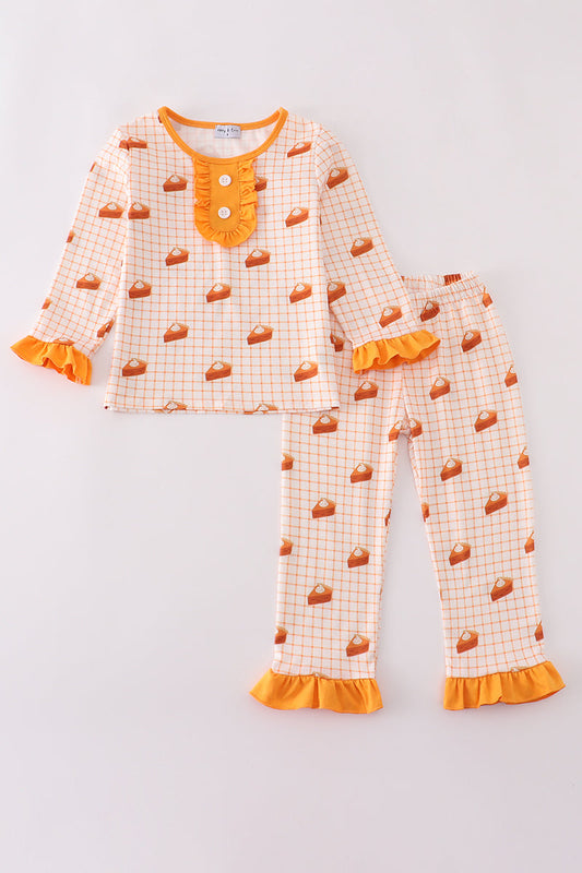 Children's pajama set with orange and white pattern on a light gray background