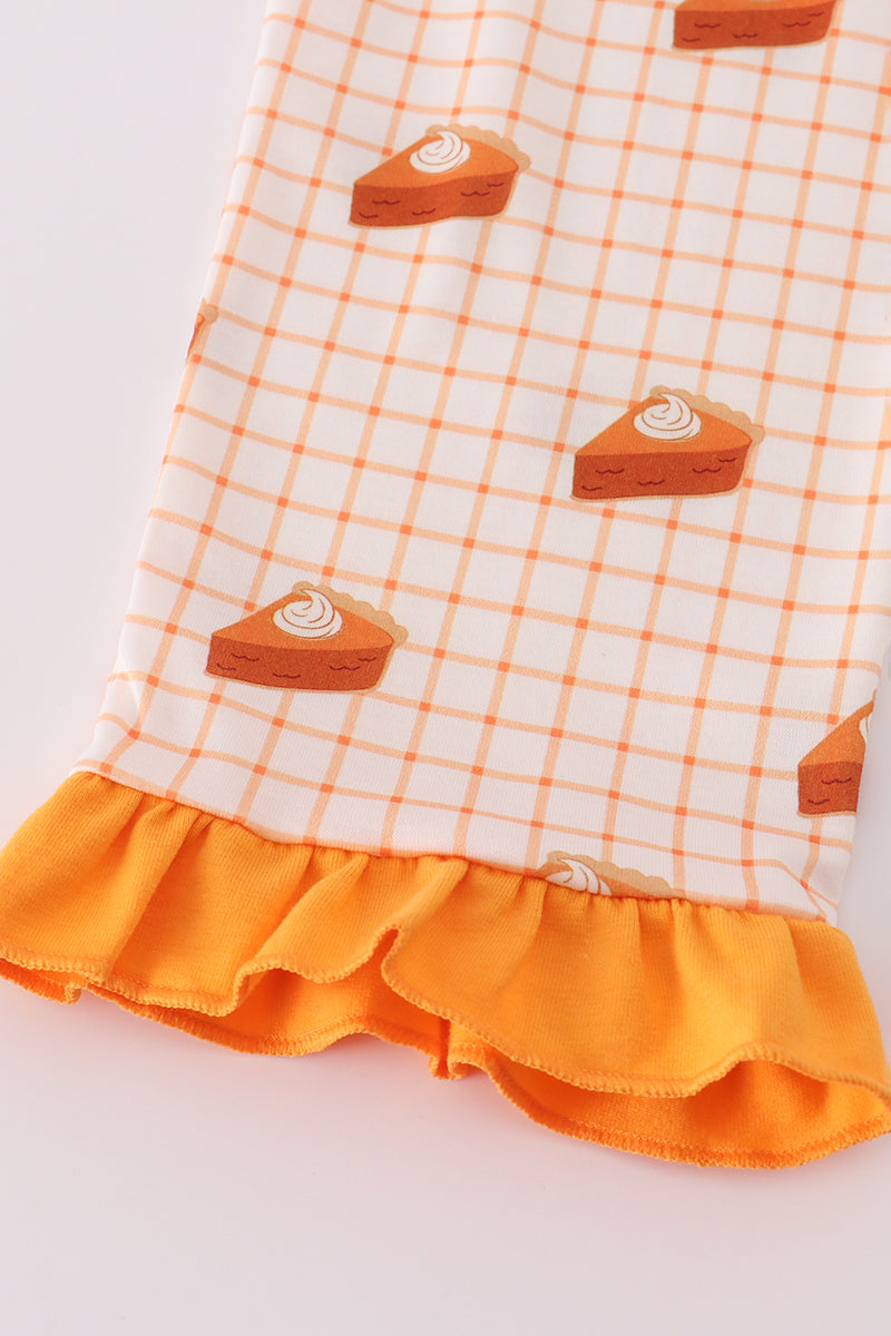 Orange and white checkered dress with pie slice patterns on a light gray background