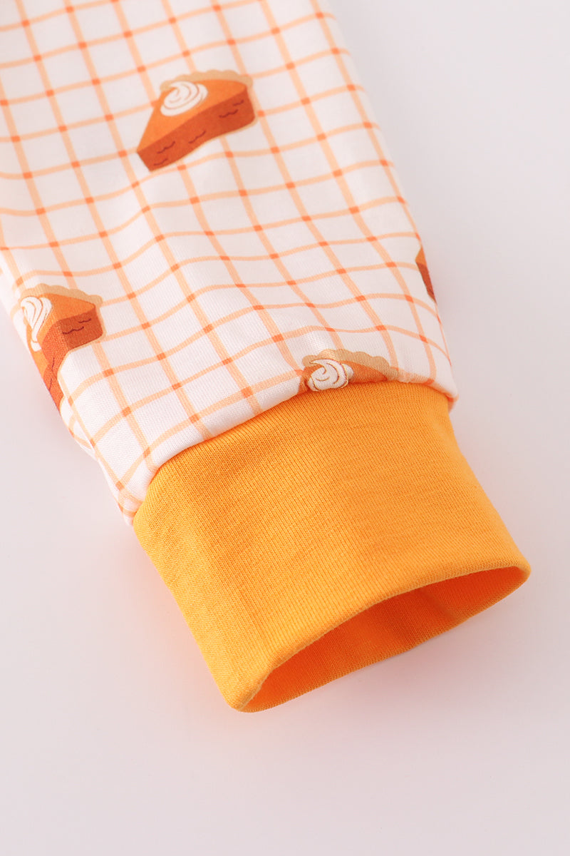 Children's outfit with orange and white checkered pattern on a light gray background