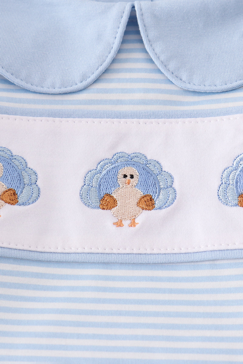 Baby outfit with blue and white striped pattern and embroidered turkey design.