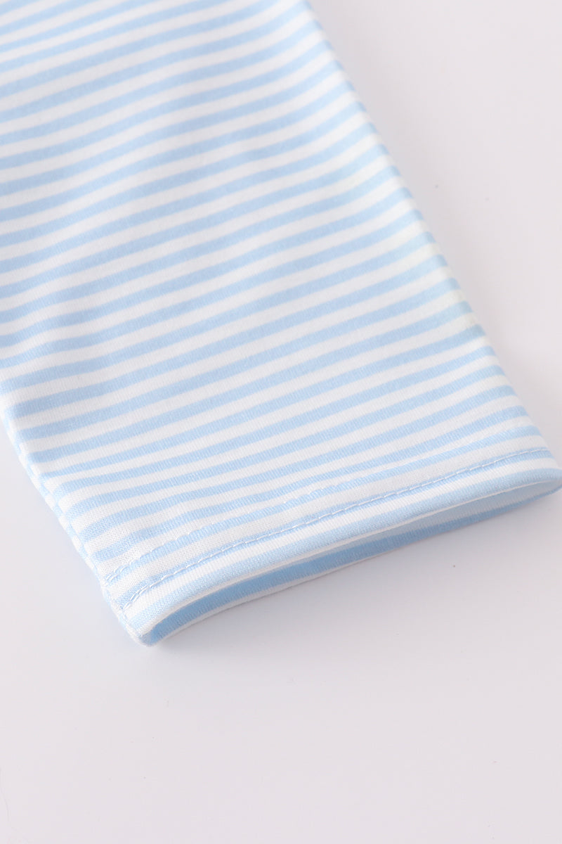 Blue and white striped fabric on a light gray background
