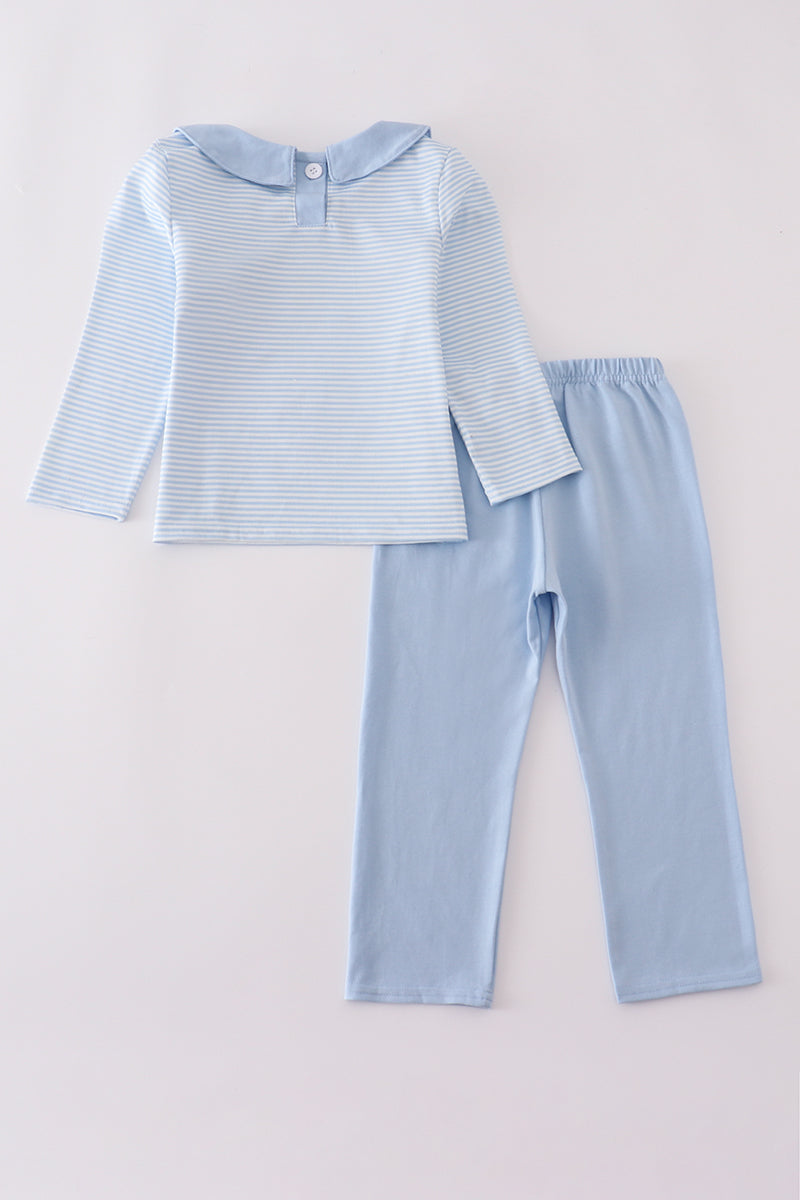 Light blue striped shirt and pants set on a light gray background