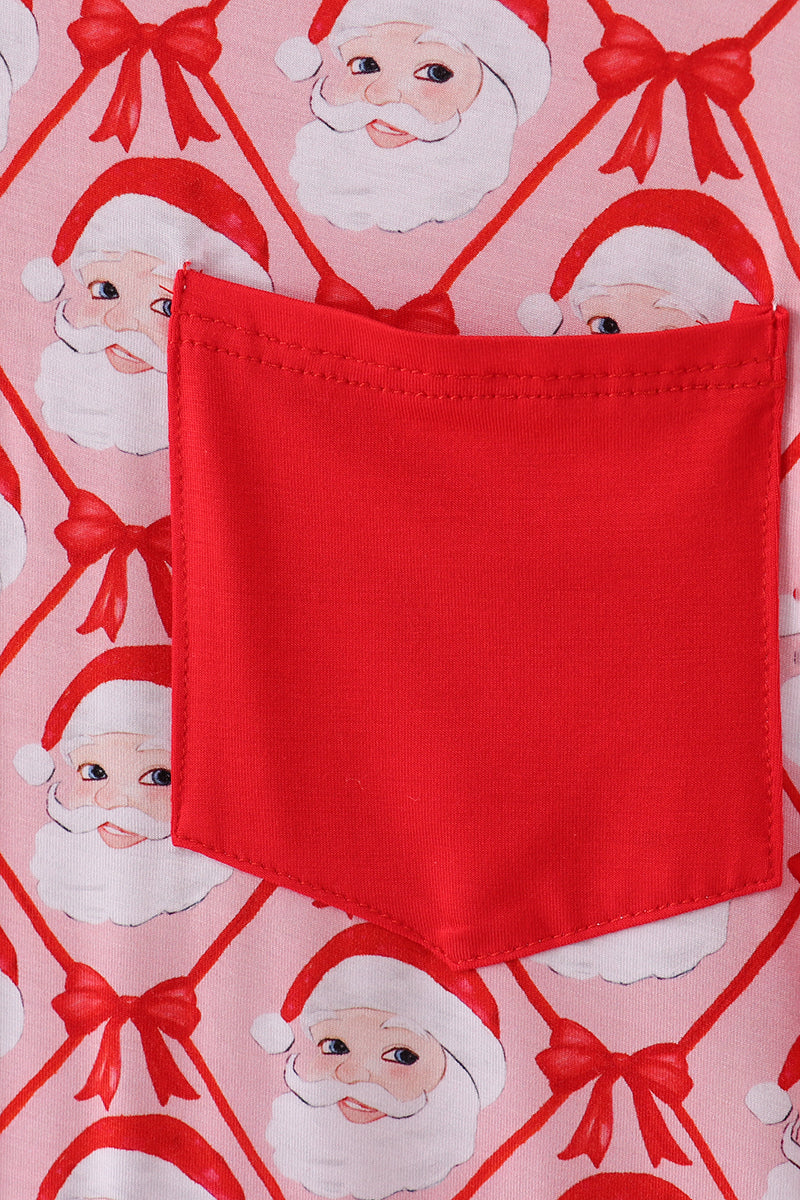 Red pocket on a fabric with Santa Claus and bow pattern