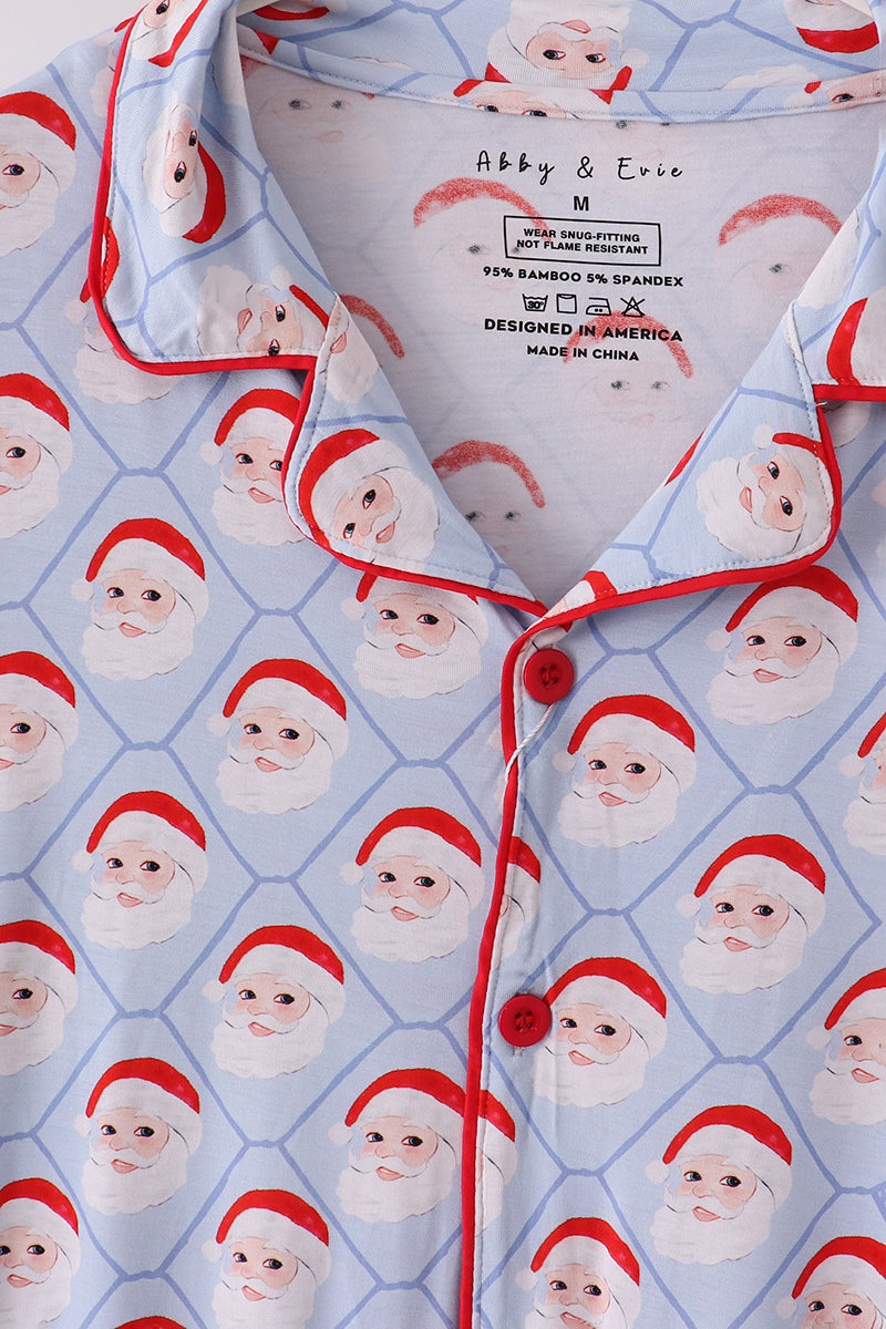 Patterned pajama top with Santa Claus faces on a blue background, brand label visible.