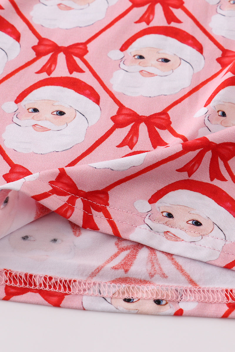 Fabric with Santa Claus and bow pattern on a pink background