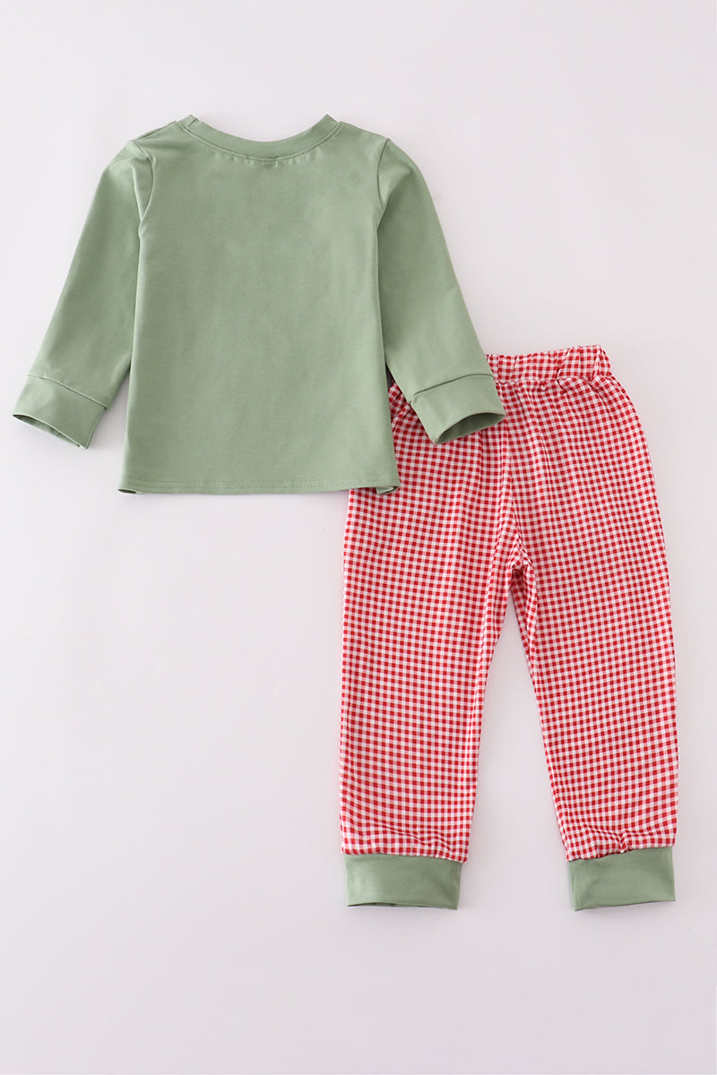 Green long-sleeve shirt and red checkered pants on a light gray background