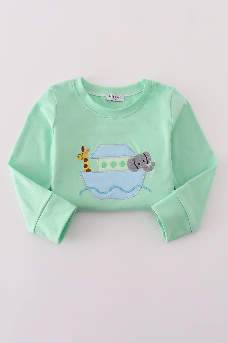 Light green long-sleeve shirt with a cartoon design on a light gray background